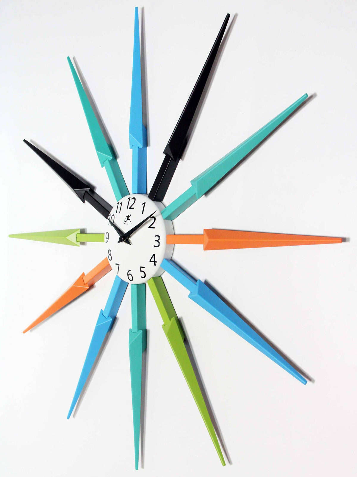 Colorful wall clock with startburst design on a white background