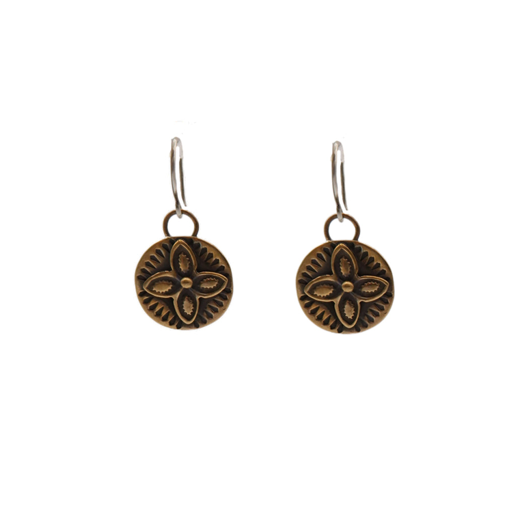Pair of bronze floral earrings on a white background