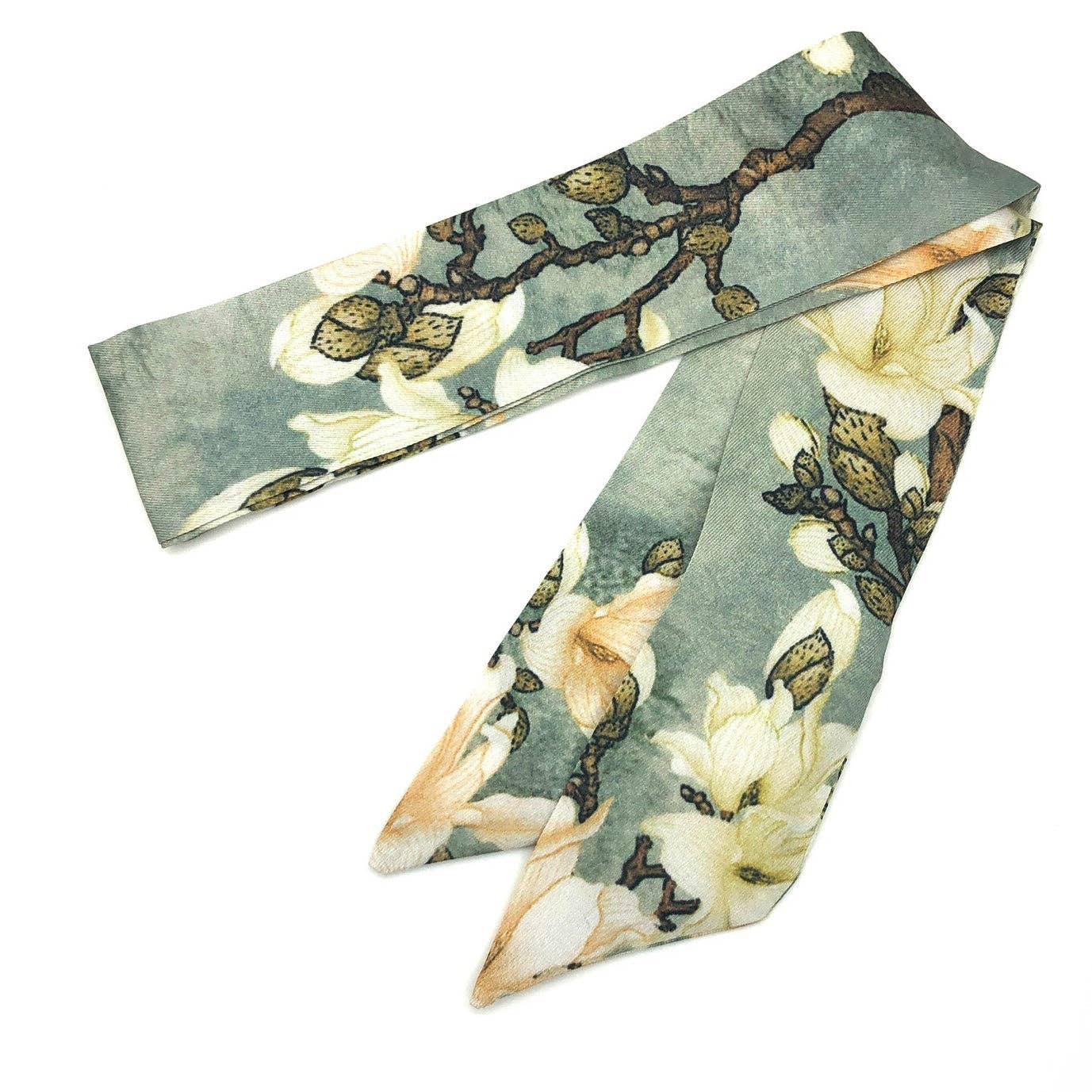 Floral patterned scarf with white flowers and green leaves on a light blue background