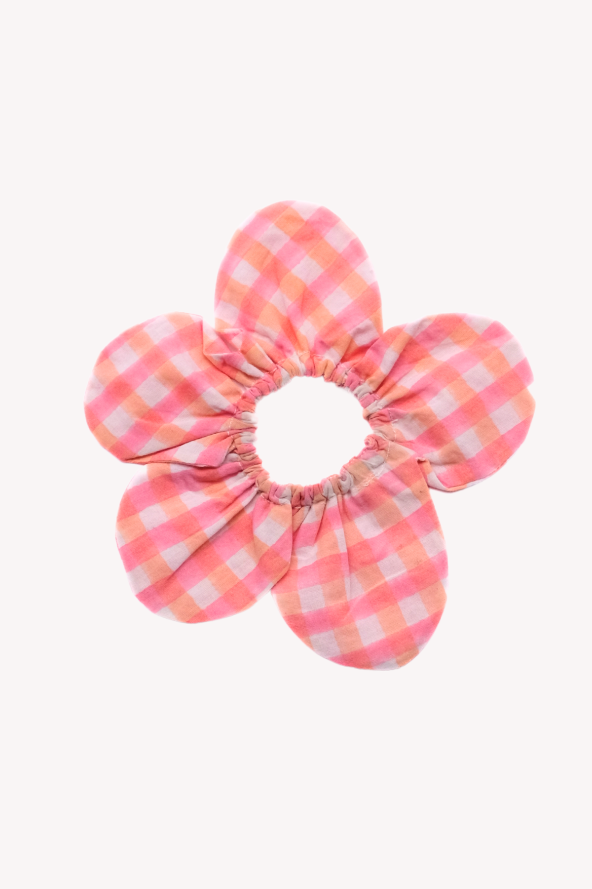 Pink and white checkered scrunchie on a white background