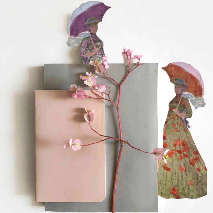 Decorative paper cutouts of women with umbrellas and flowers on a white background