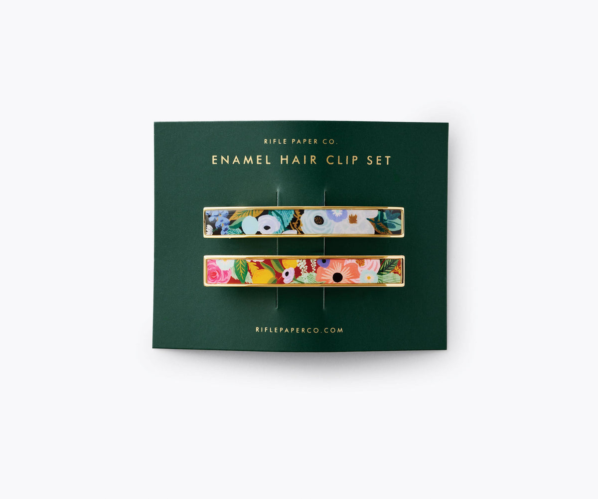 Enamel hair clip set packaging with floral designs on a green background