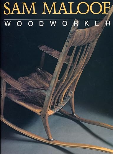 Wooden rocking chair with 'Sam Maloof Woodworker' text on a dark background
