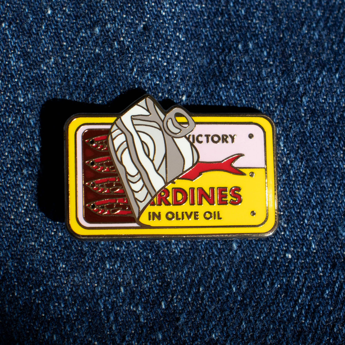 Sardines yellow pin against denim background