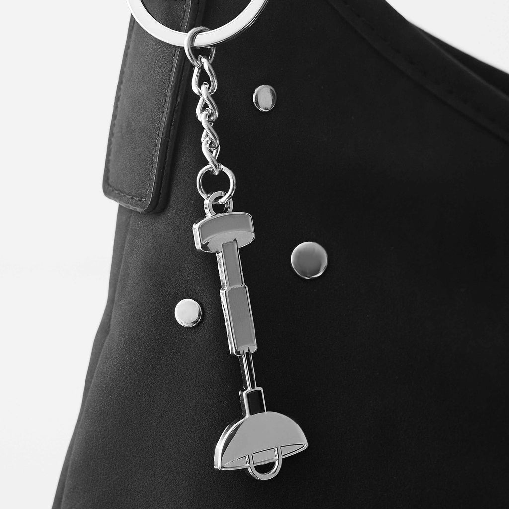 Silver keychain attached to a black leather bag
