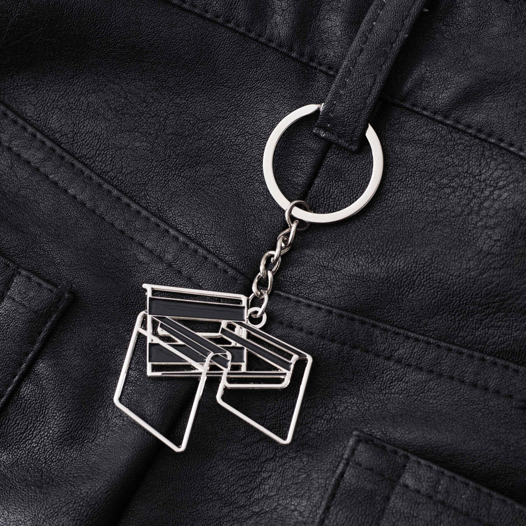 Keychain shaped like a chair on a black leather pants belt hoop. 