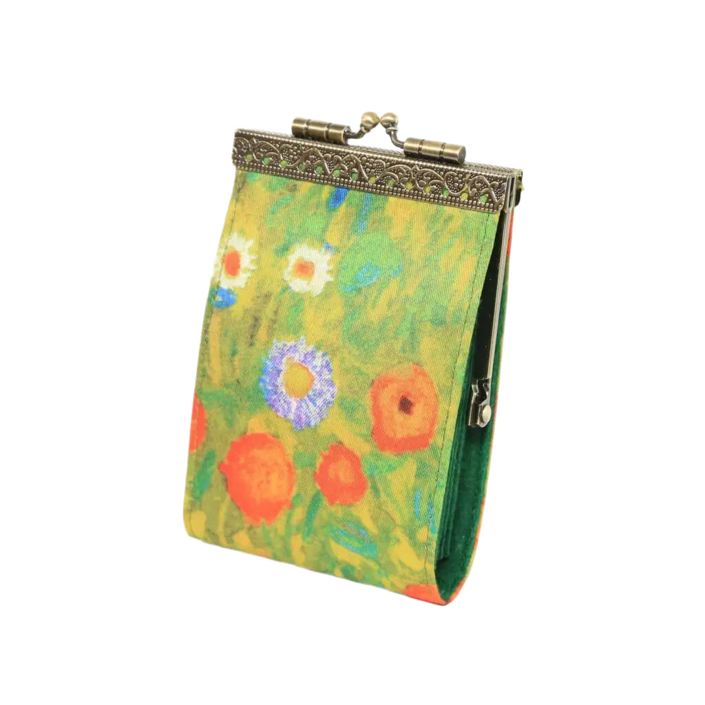 small pouch with orange and blue flowers with gold hardware on a white background