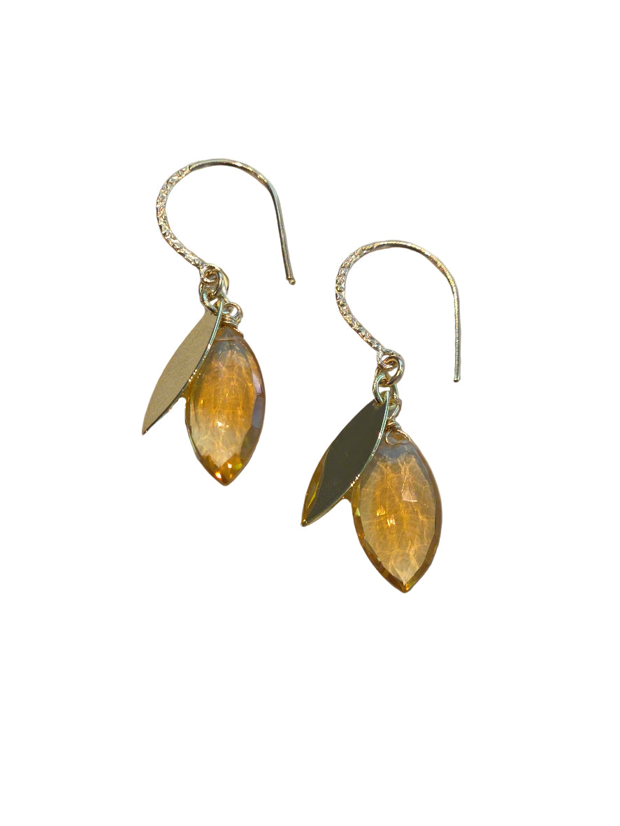 Pair of earrings with leaf-shaped yellow stones on a white background