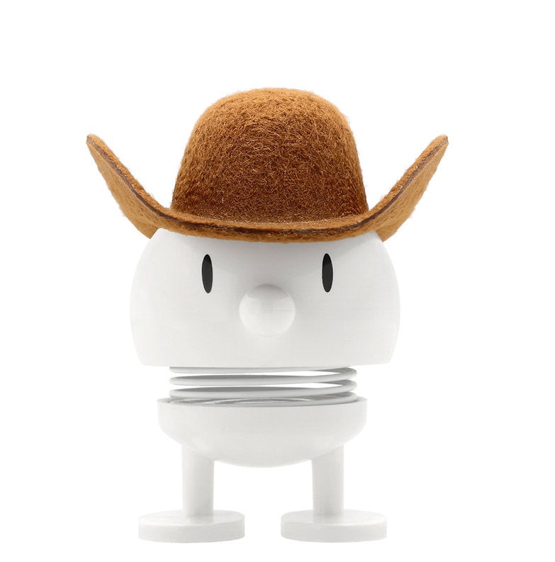 A white figurine with a coil neck with a cowboy hat, black eyes.