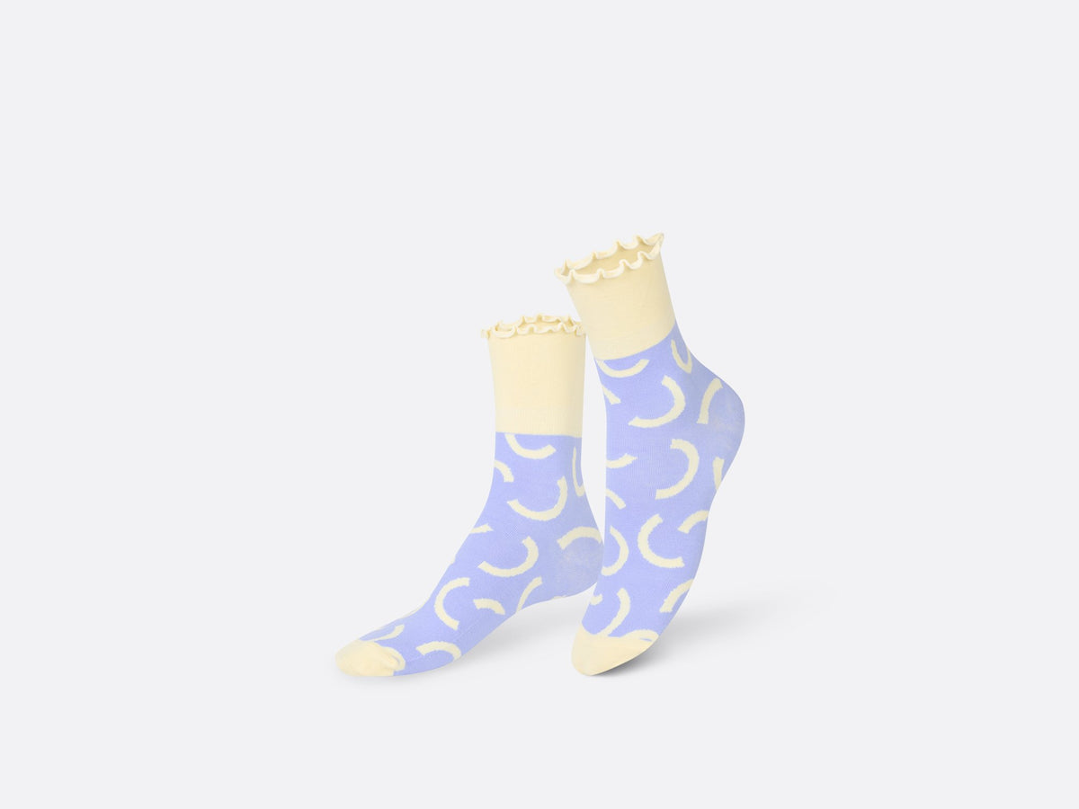 Socks with cream cuffs and purple middle and cream half circles.