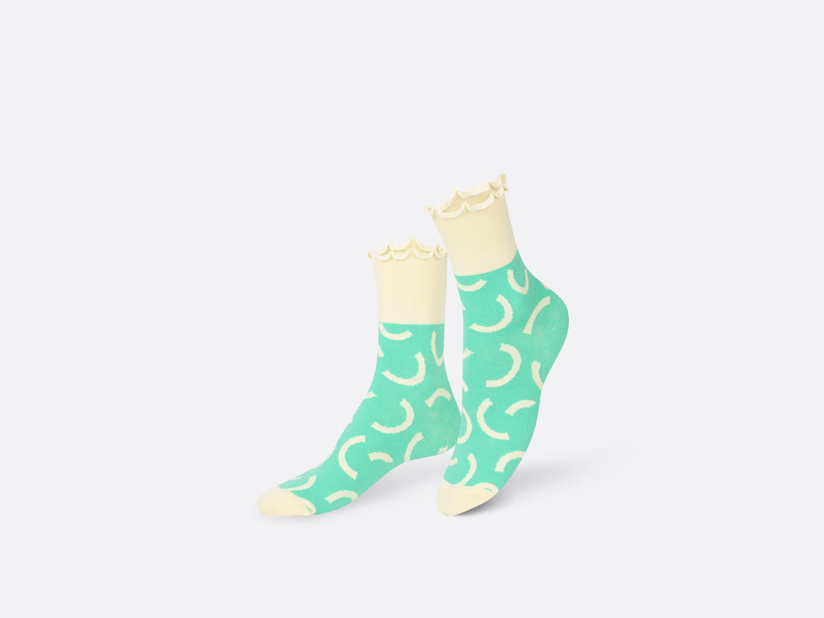Socks with cream cuffs and turquoise middle and cream half circles.