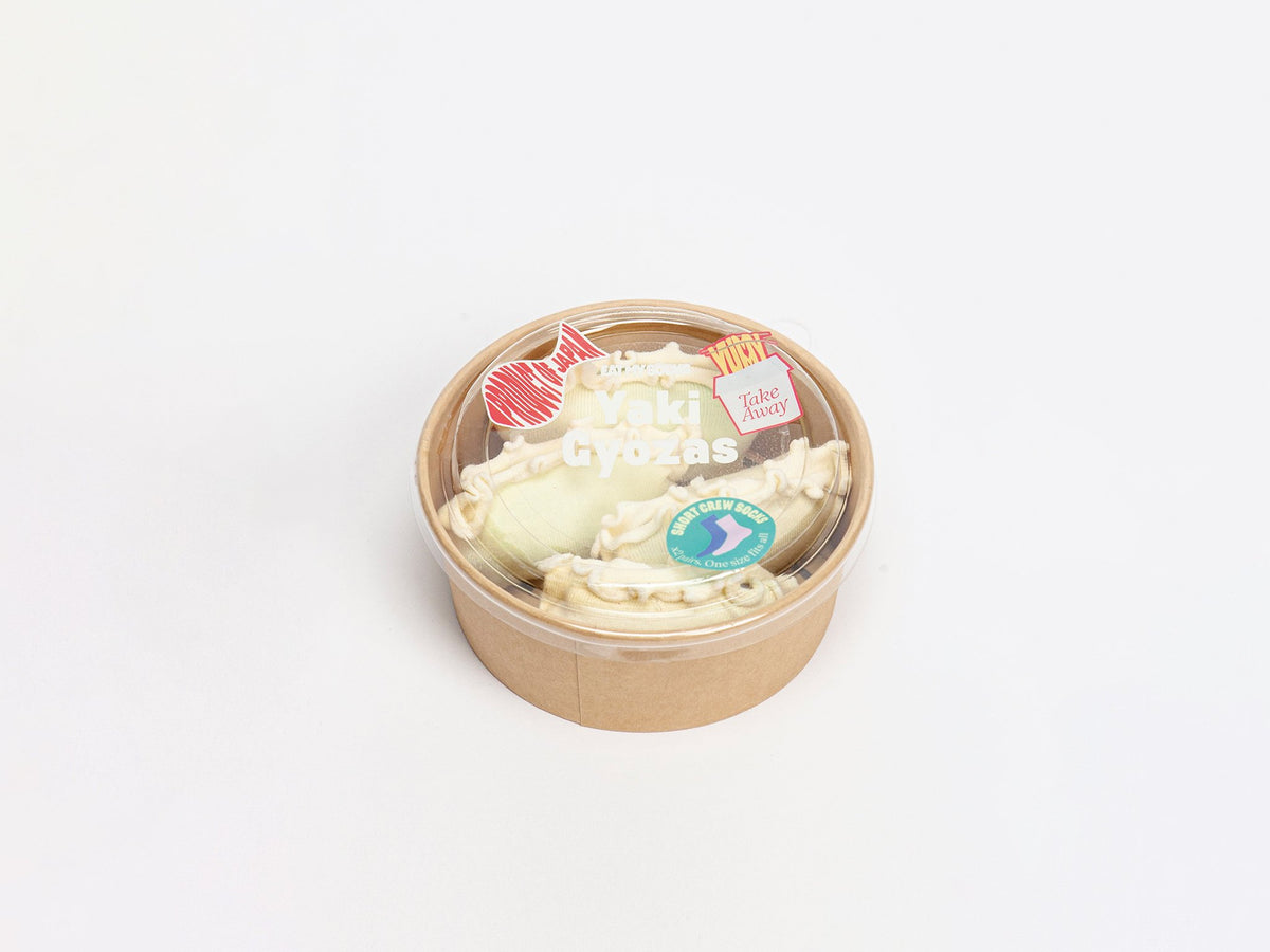 Brown paper bowl with cream pillows and white text on the lid.