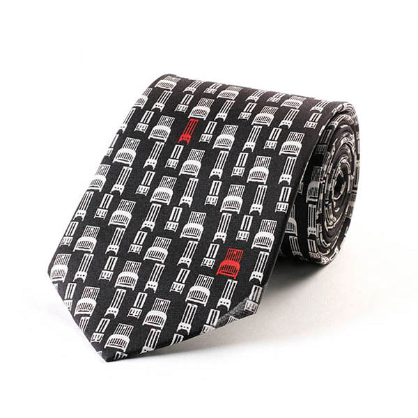 Roll of patterned tie with geometric design on a white background