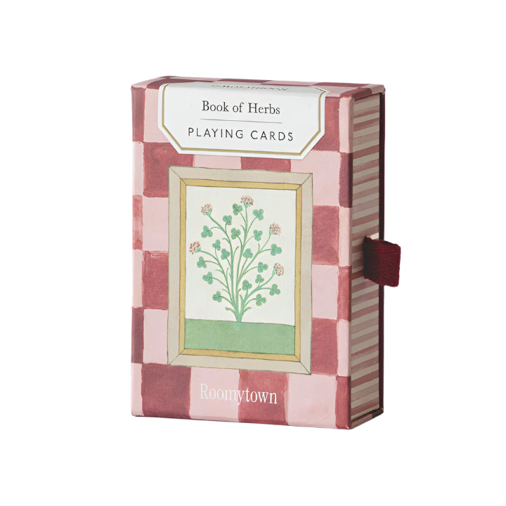 Playing cards with a 'Book of Herbs' design on a white background