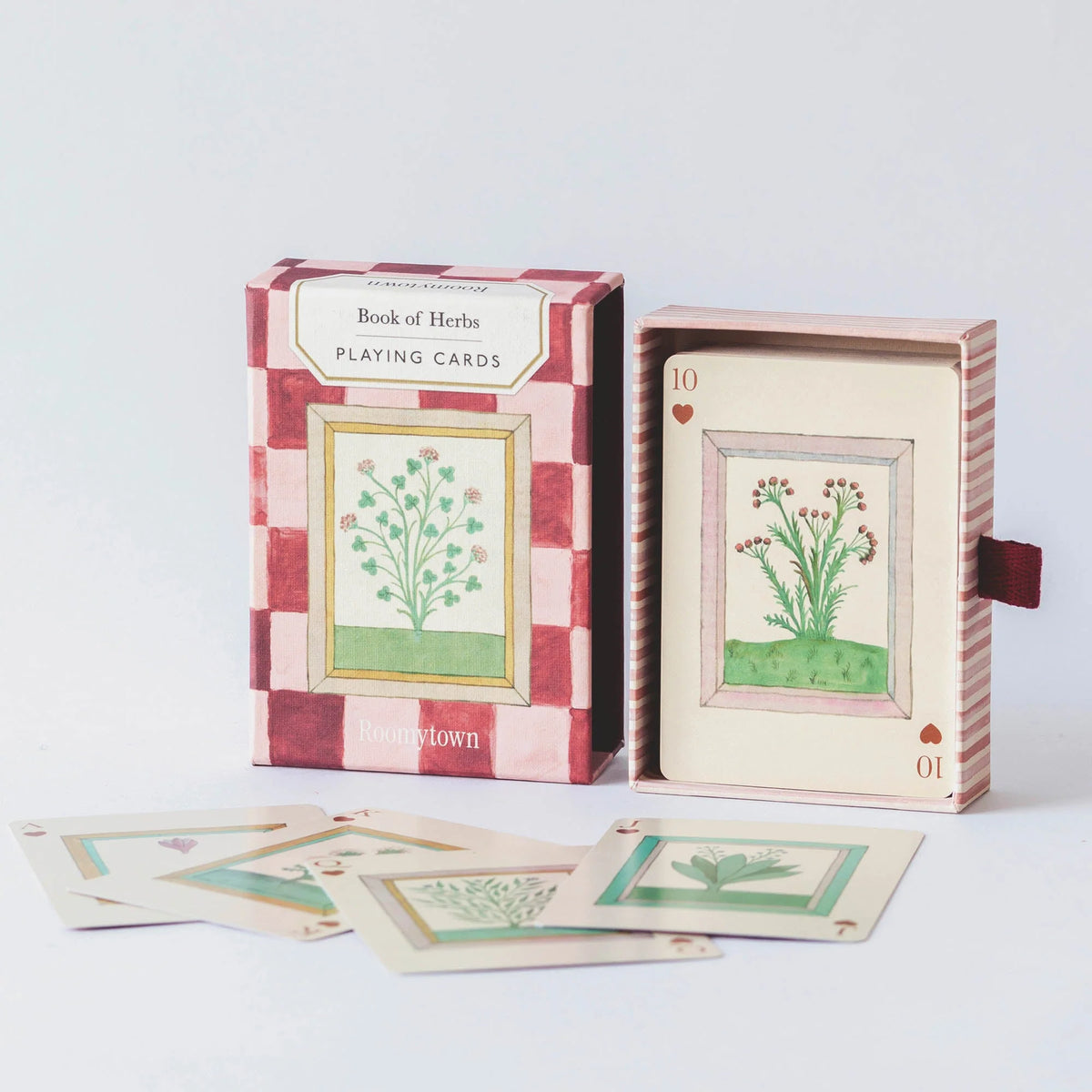 Playing cards with botanical designs in a checkered box on a white background