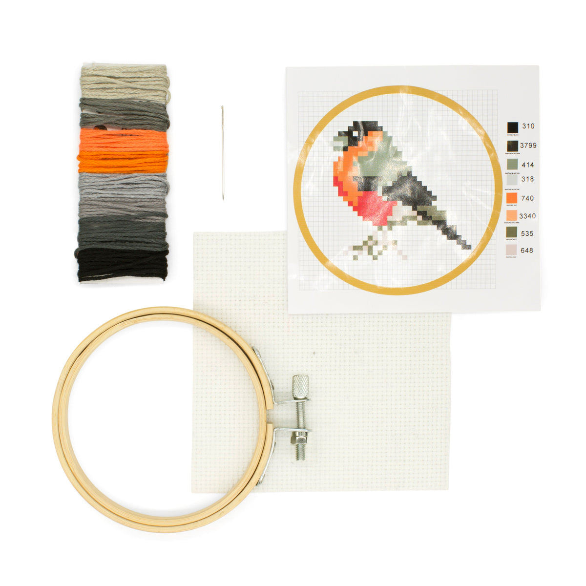 Embroidery kit with hoop, thread, and cross-stitched bird design on a white background