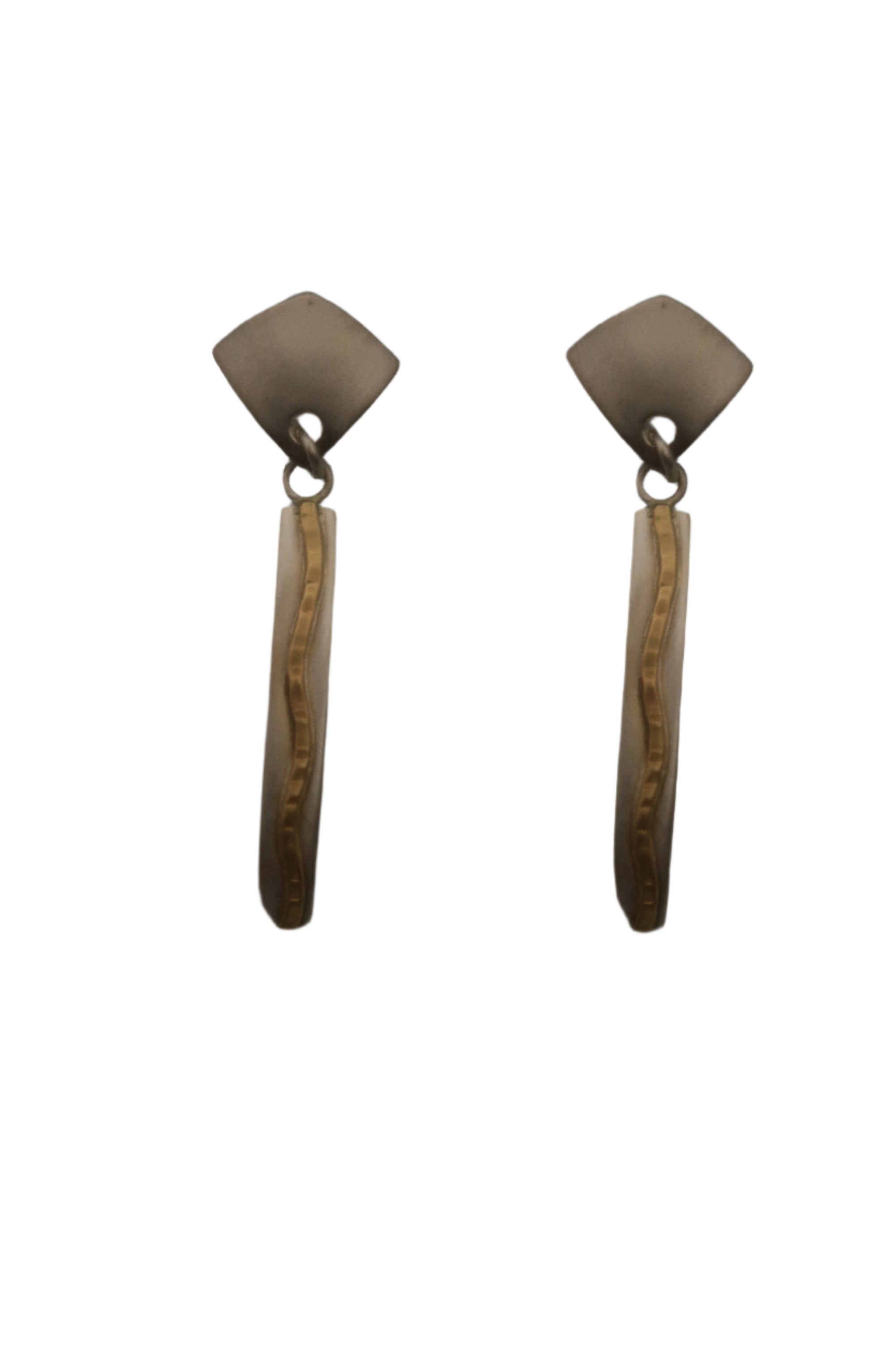 Pair of earrings with gold and silver design on a gray background