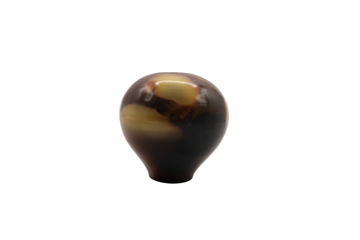 Marbled brown and beige egg shaped ceramic vase on a white background