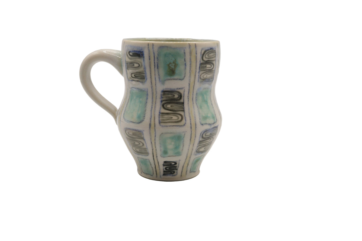 Ceramic mug with decorative patterns on a white background