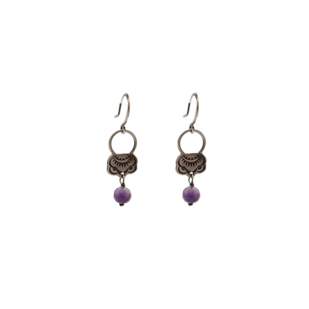 Pair of earrings with purple beads on a white background