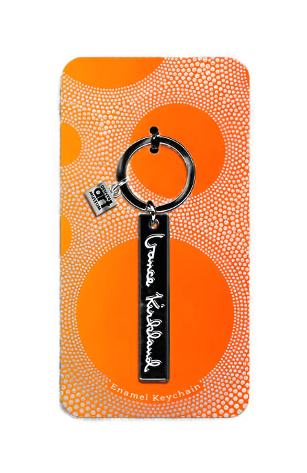 Keychain packaging with orange and white pattern on a beige background