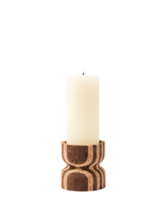 Candle in a decorative cork holder on a white background