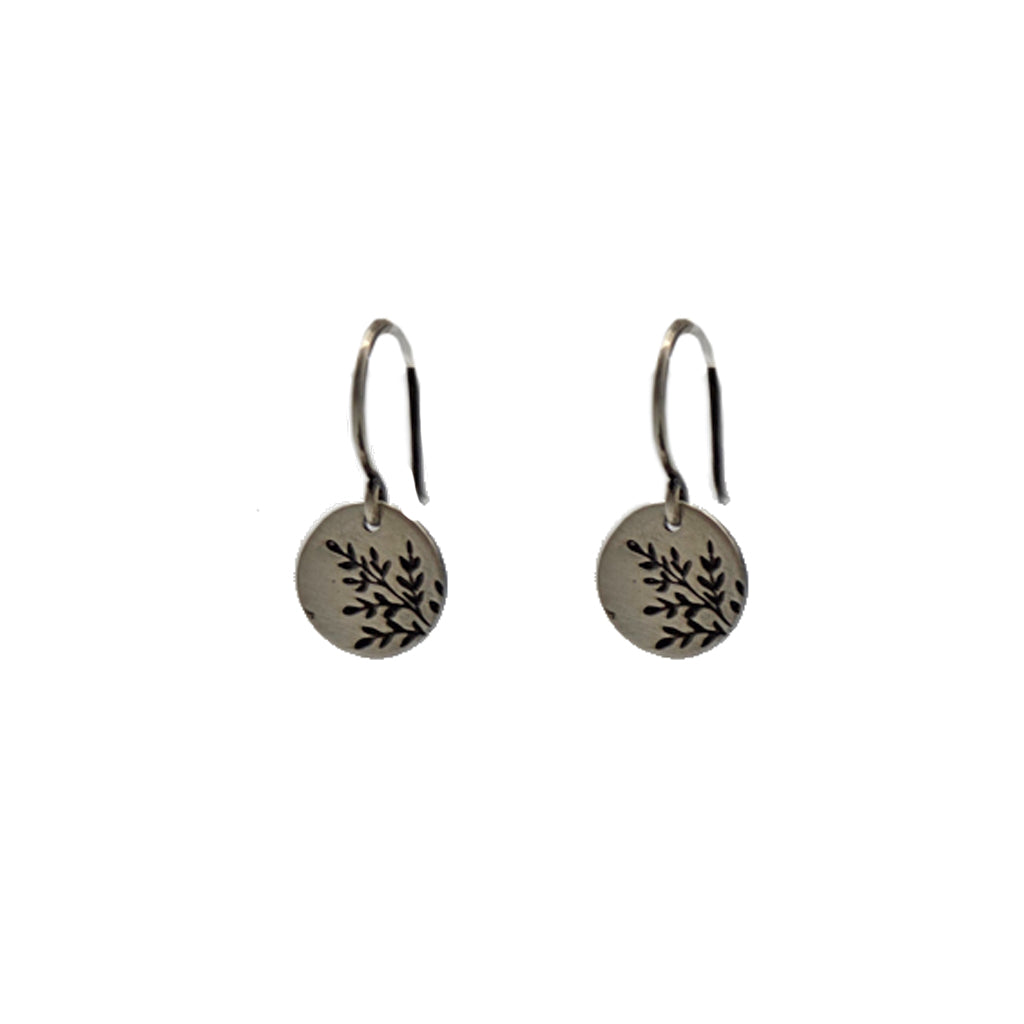 Pair of silver earrings with leaf design on a white background