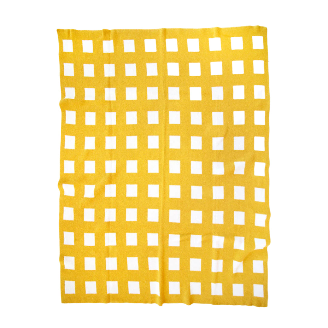 Blanket with yellow fabric with a white grid pattern on a white background