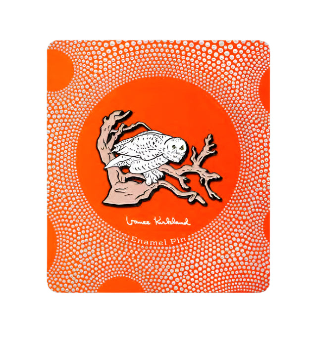 Enamel pin packaging with a bird design on an orange background