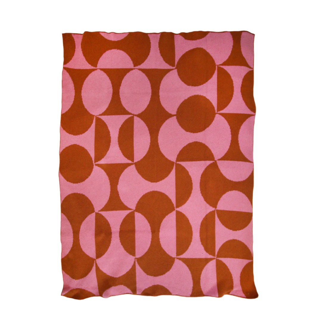Pink and brown patterned blanket on a white background