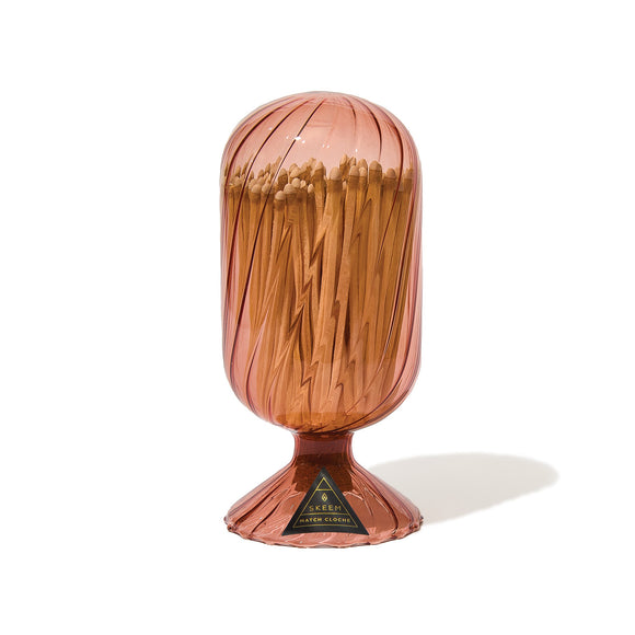 Cylindrical container filled with matches on a white background