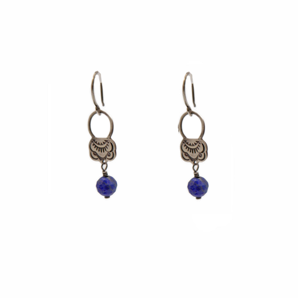 Pair of earrings with blue beads on a white background