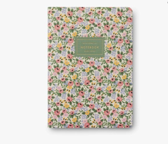 Pastel floral notebook with a green label on a white background