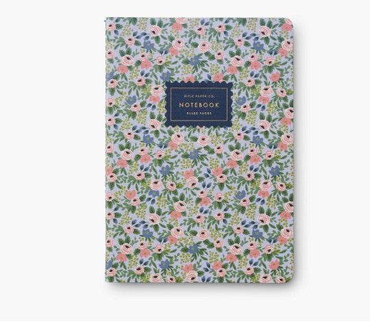 Blue and pink floral notebook with a visible brand label on a white background
