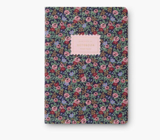 Red and pink floral notebook with a pink label on a white background