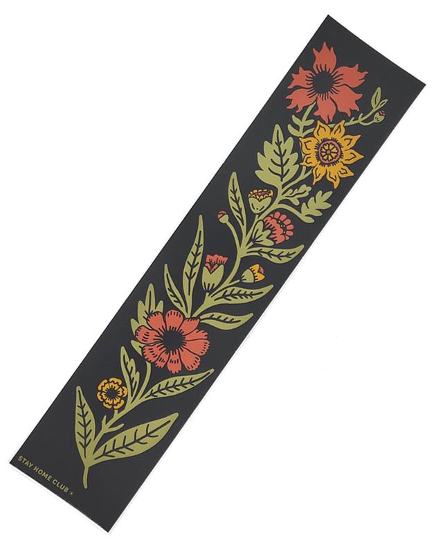 A matte bumper sticker with a floral design, featuring red, orange, yellow, and green flowers on a black background.