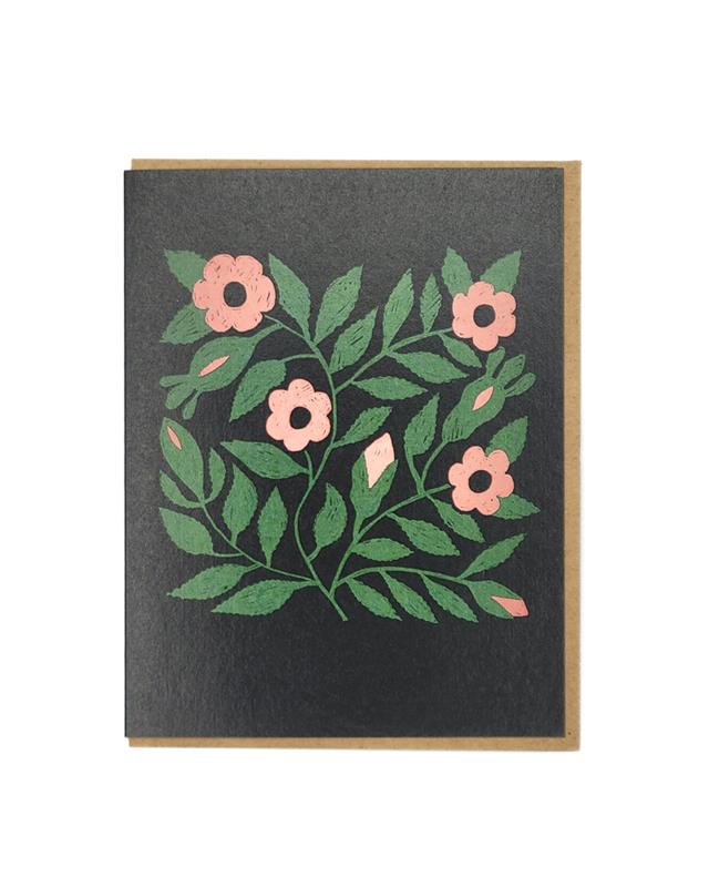 A folded greeting card with a floral design, featuring green leaves and pink flowers, with a brown envelope and white background