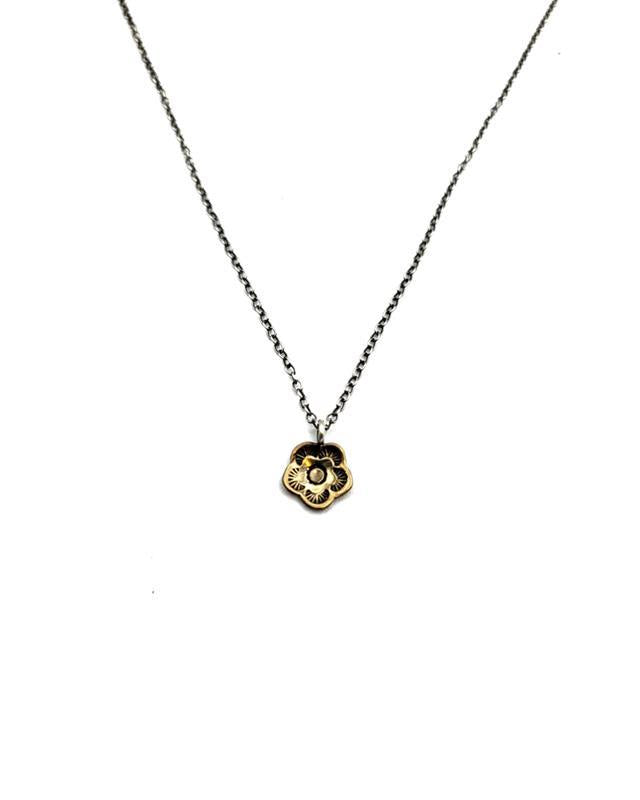 A sterling silver chain necklace with a bronze floral pendant at the center, displayed against a white background.