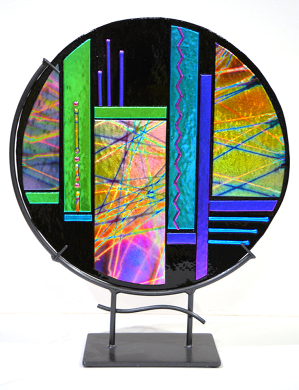 Colorful abstract glass artwork on a stand with a white background