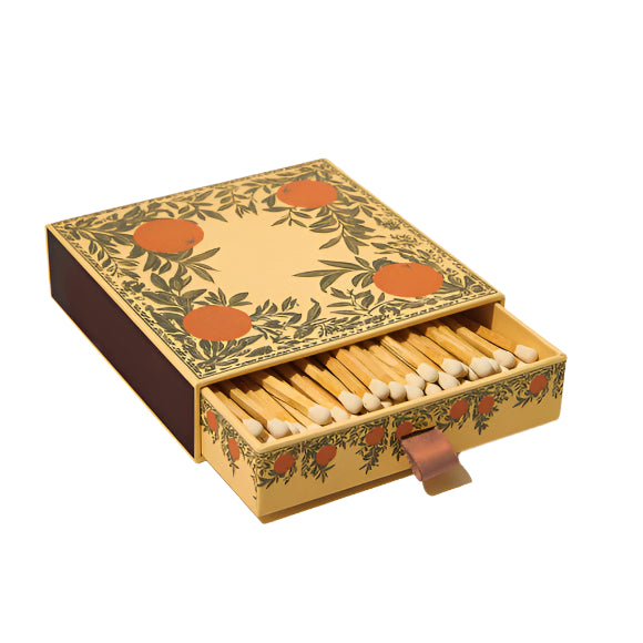 Decorative matchbox with oranges  with matches inside on a white background