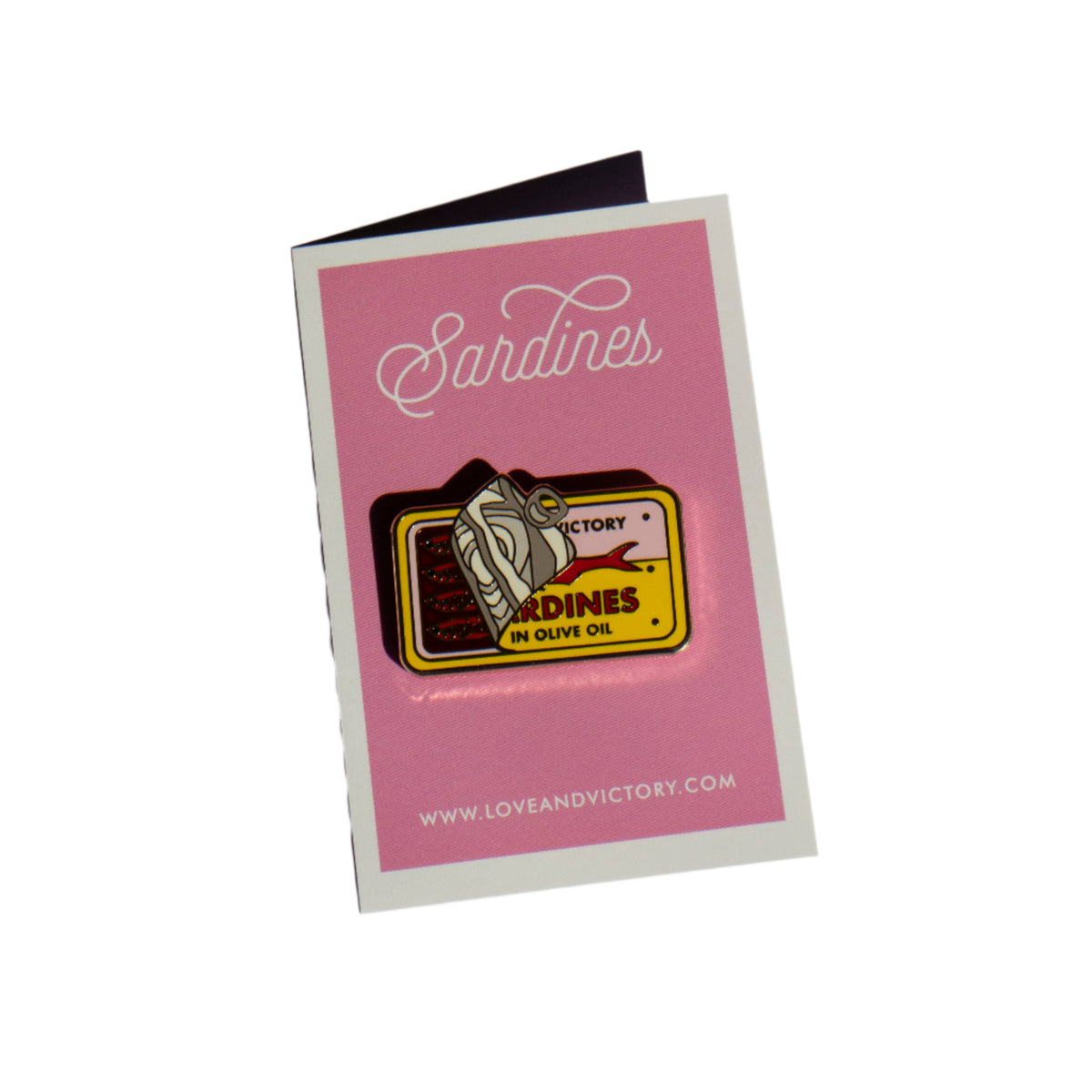Enamel pin on a pink card with &#39;Sandines&#39; branding