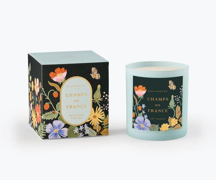 Candle and its packaging with floral design on a white background