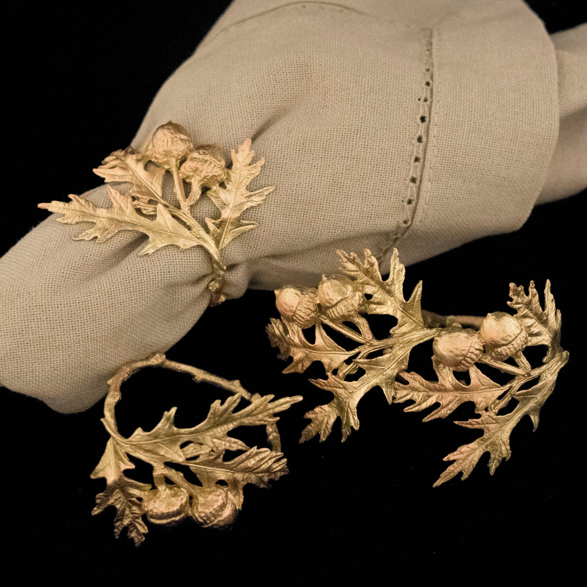 Gold leaf-like decorative elements on a beige fabric background