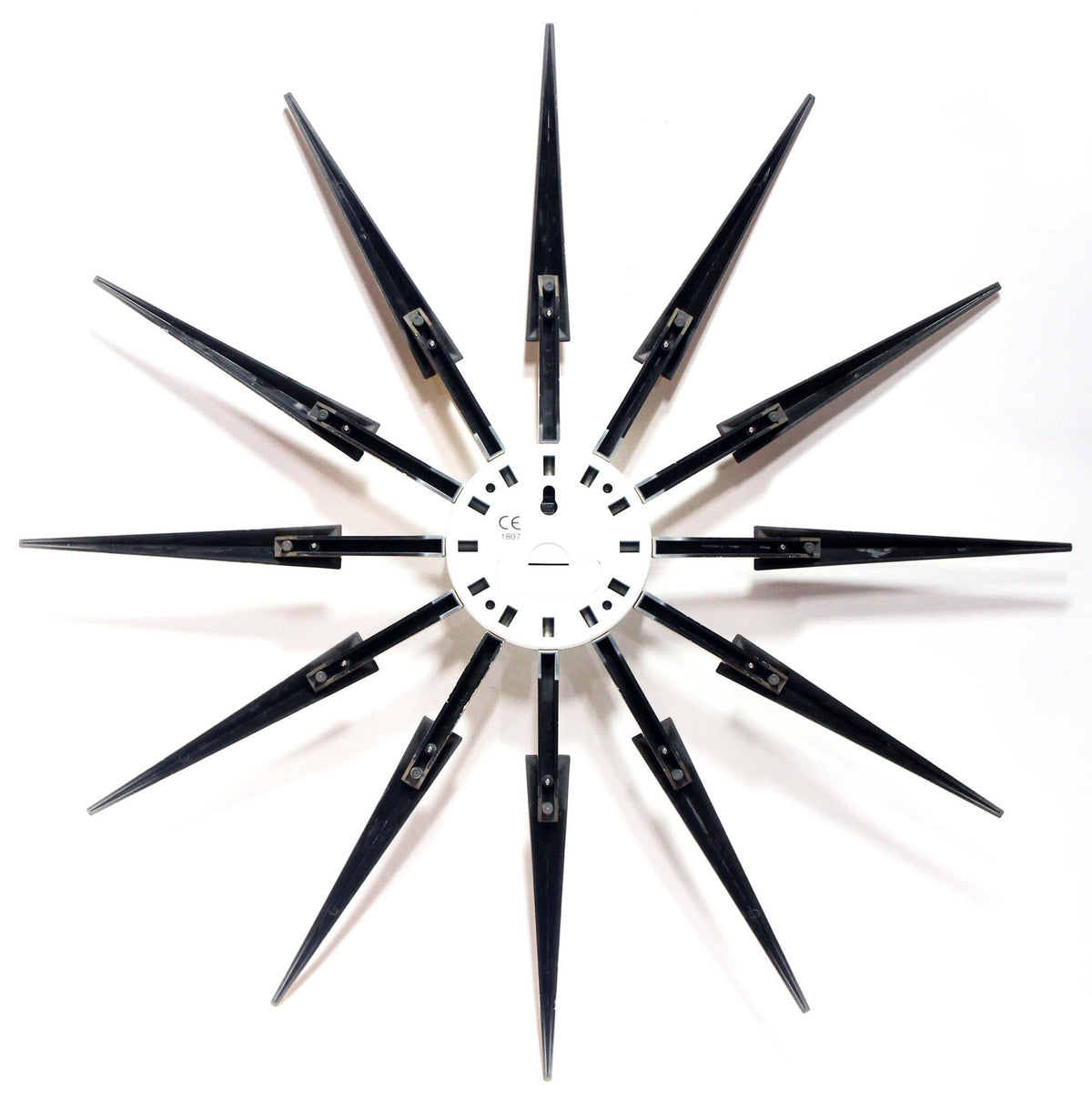 The back of a starburst wall clock on a white background