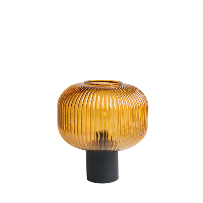 Decorative lamp with ribbed design on a white background