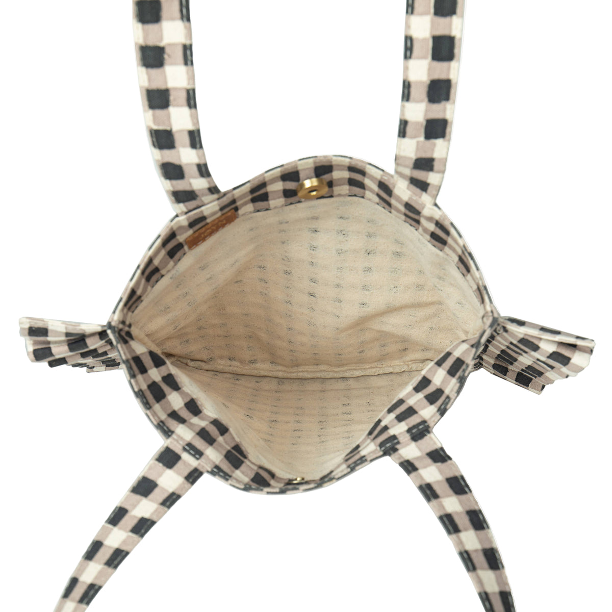 Inside of woven bag with checkered straps on a white background