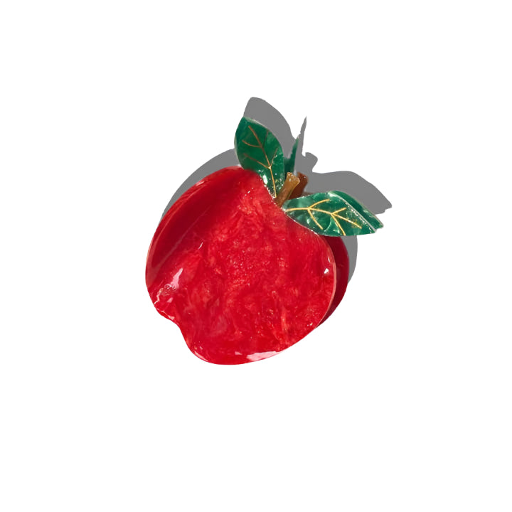 Red apple-shaped object with a green leaf on a white background