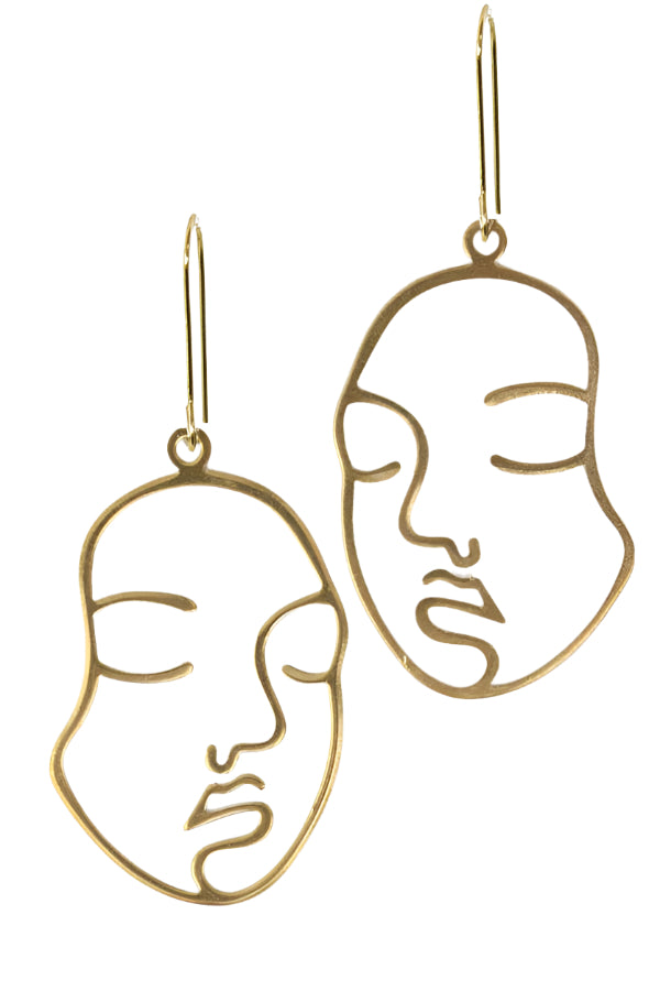 Gold face-shaped earrings on a white background