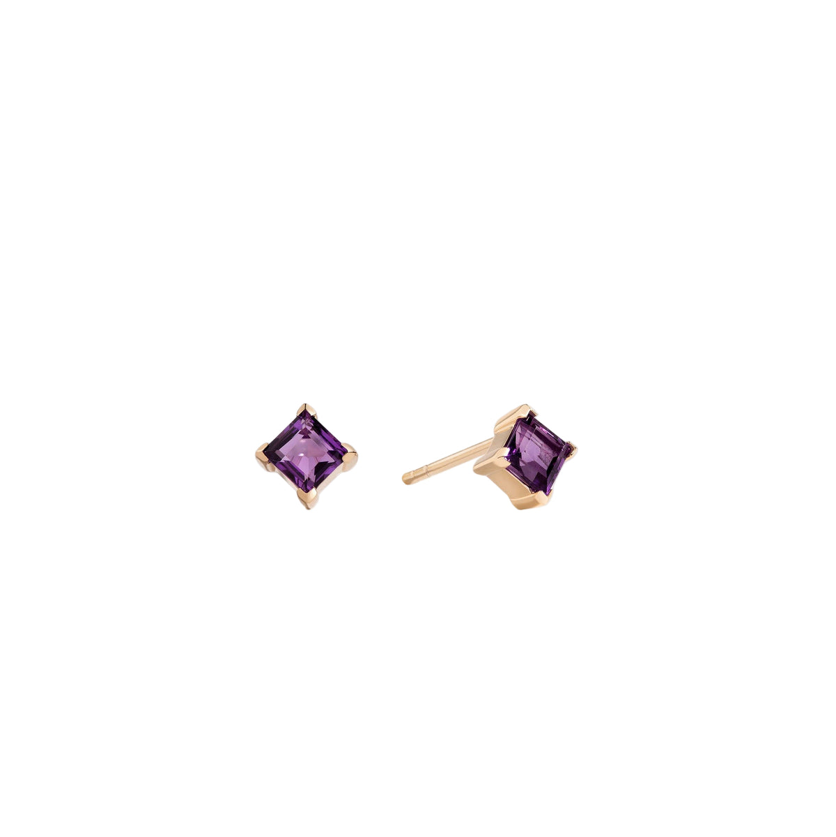 Pair of gold earrings with purple gemstones on a white background