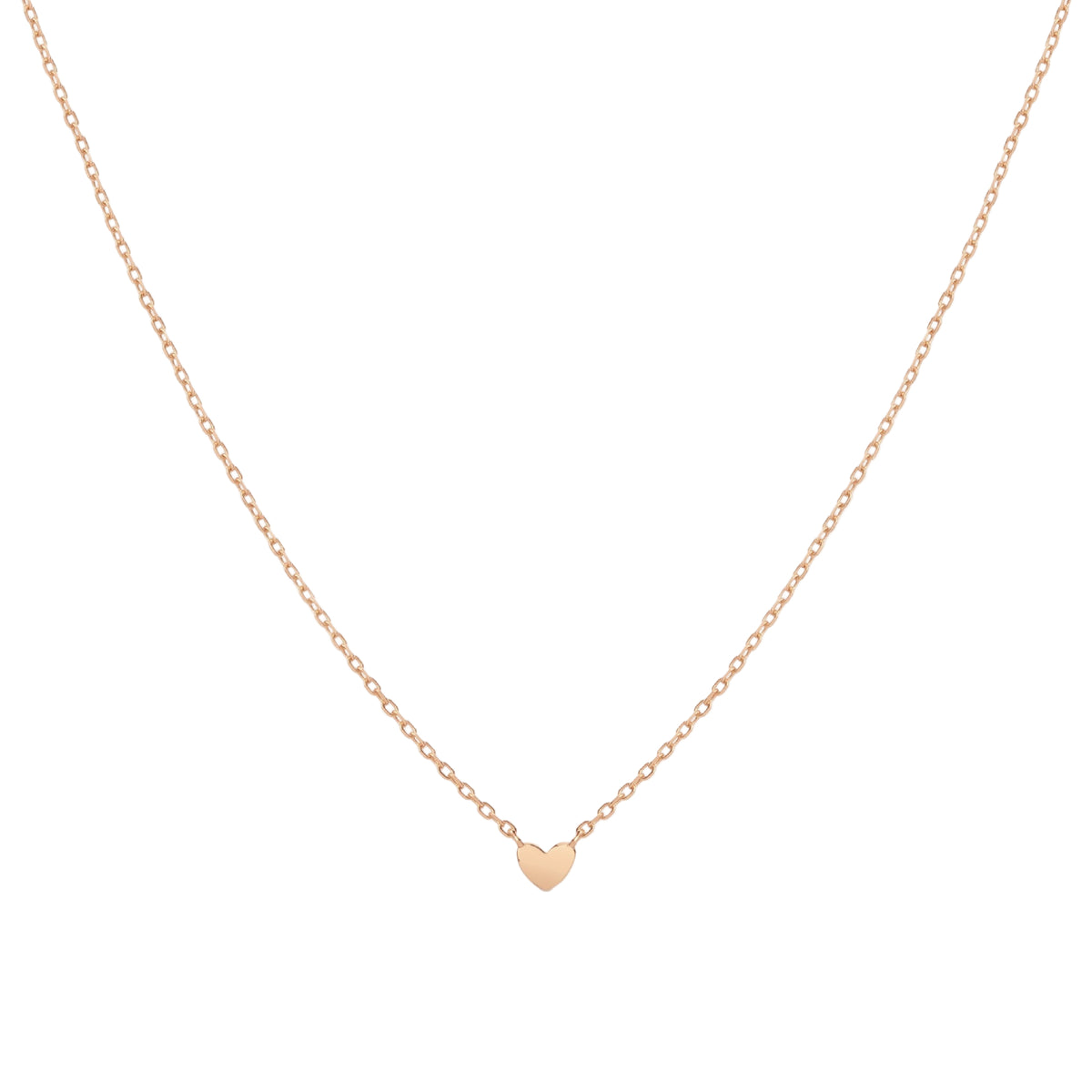 gold heart-shaped pendant necklace on a light beige background